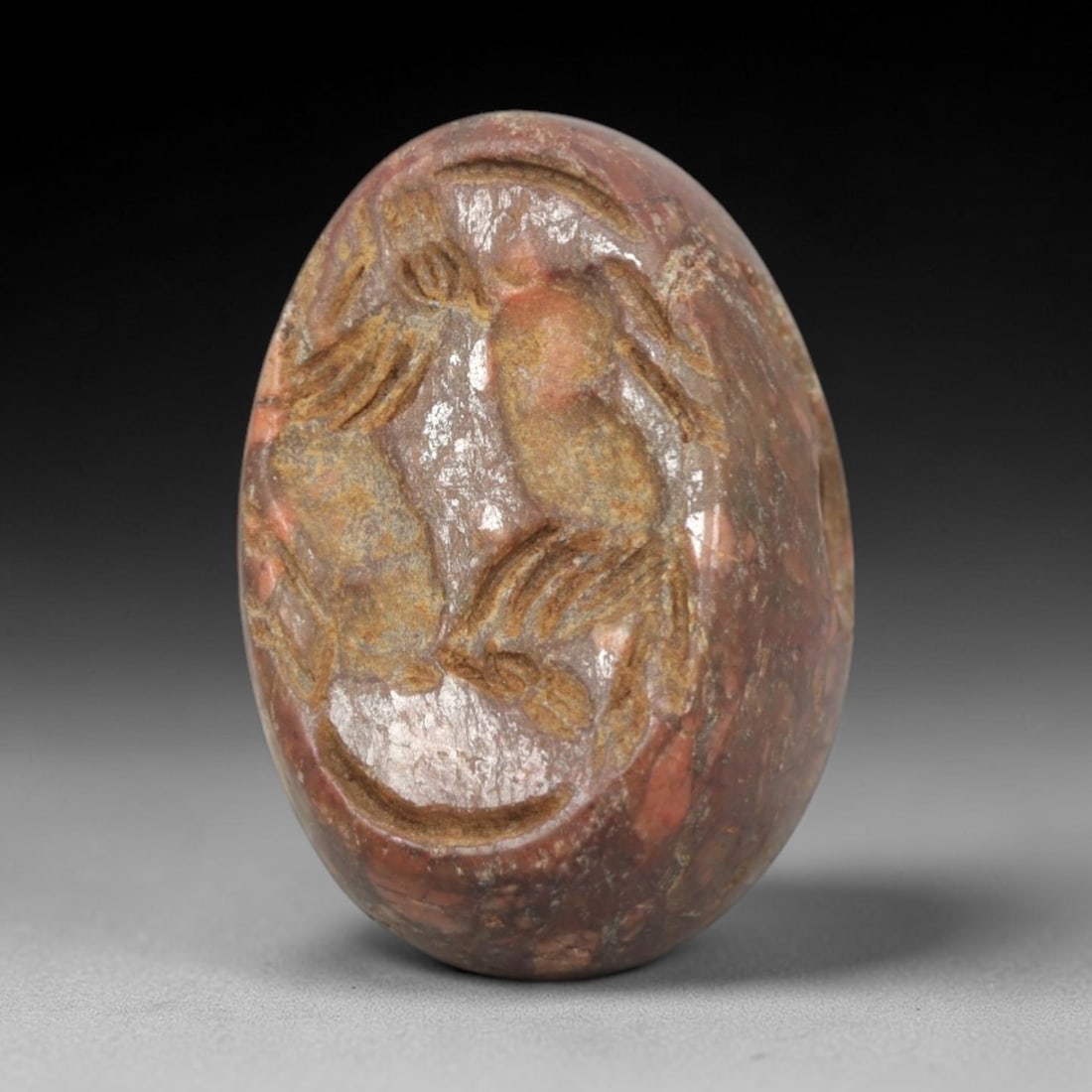 Ancient Stone Hemispherical Stamp Seal - Near Eastern Animal Pair Figure, 40ZS: Crafted from dense, reddish-brown stone, this hemispherical stamp seal bears incised carving of two stylized animal figures, likely hares or rodents, with linear body detailing, ear motifs, and dynami