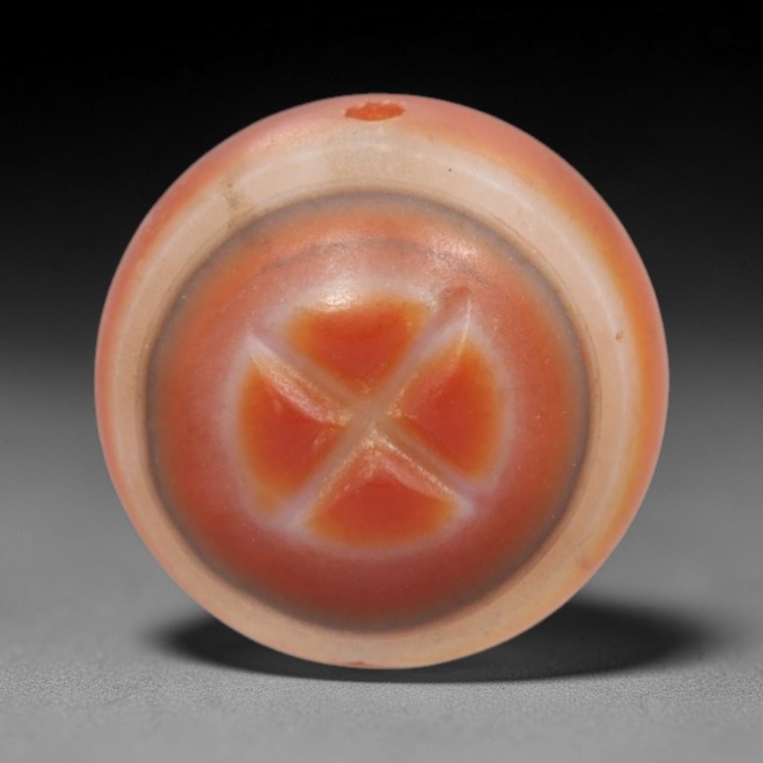 Antique Agate Four-Petal Cross Bead - Central Asian Protective Amulet Pendant, 17ZW: Carved from banded agate with a warm peach-orange base and creamy white concentric banding, this bead features a symmetrical four-petal cross motif with raised, faceted segments arranged in a cross pa