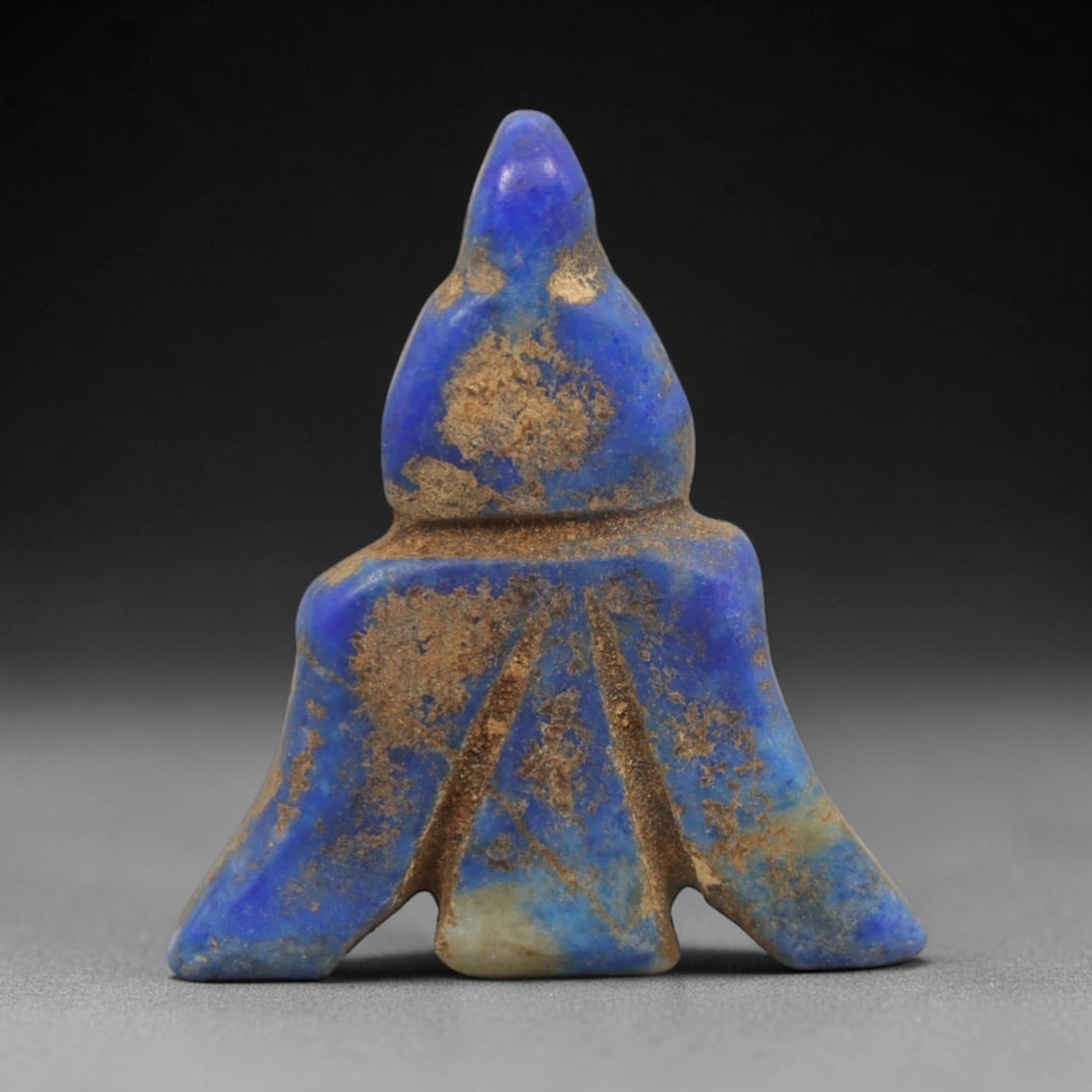 Ancient Lapis Lazuli Fly Amulet - Egyptian Ritual Pendant, 34ZT: Carved from lapis lazuli, this amulet is formed in the shape of a fly, with a pointed upper head pierced for suspension and a flared, segmented lower body incised with linear details to define the ins