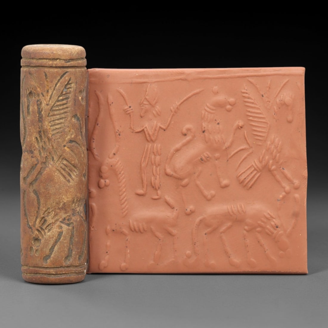 Ancient Steatite Cylinder Seal - Mesopotamian Mythological Combat Scene, 93ZR: Carved from dense steatite, this ancient Mesopotamian cylinder seal presents a detailed mythological combat scene in linear relief, featuring a human figure with weapons alongside winged and quadruped