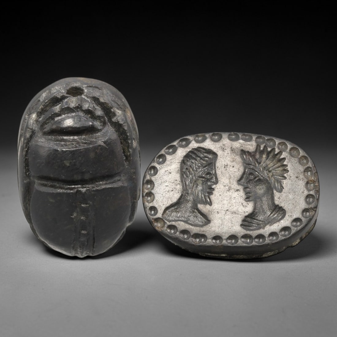 Ancient Hardstone Scarab - Near Eastern Confronted Figural Seal, 33XT: This artifact is hand-carved from a dark, fine-grained hardstone, utilizing traditional ancient seal craftsmanship consistent with Near Eastern or Phoenician Iron Age traditions. The object takes the