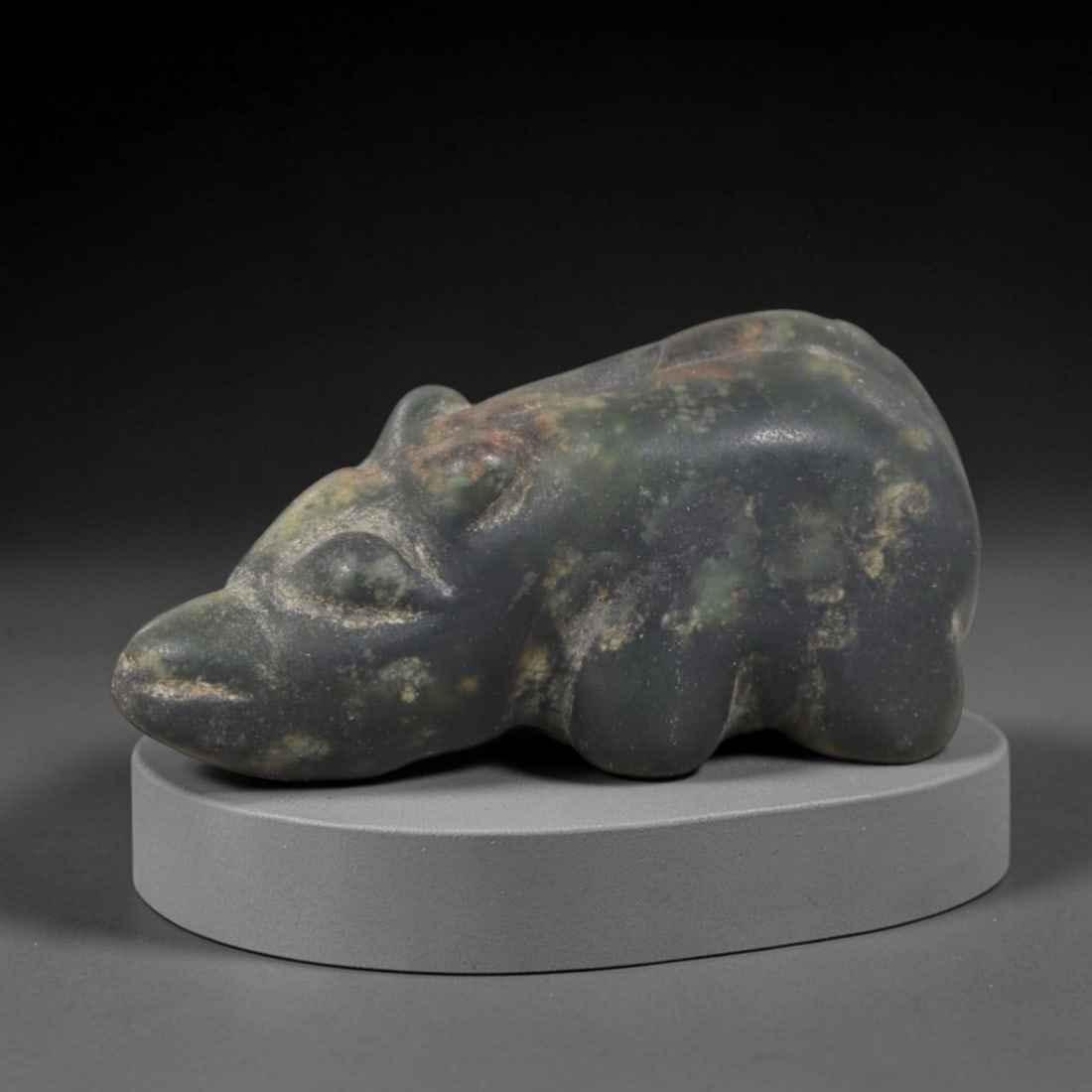 Ancient Stone Hippopotamus - Egyptian Animal Figurine, 89AP: This artifact is carved from variegated green stone with a weathered, matte patina and natural mineral inclusions, exhibiting simplified, stylized features consistent with ancient Egyptian stoneworkin