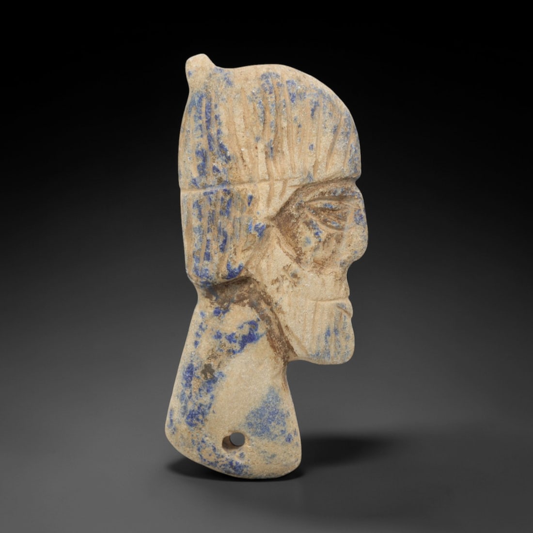 Ancient Lapis Lazuli Noble Plaque - Egyptian Amulet Figure, 67ZQ: Carved from deep blue lapis lazuli, this noble plaque features a stylized human head with distinctive facial detailing and a crested headdress. The stone exhibits a rich, natural patina with subtle py