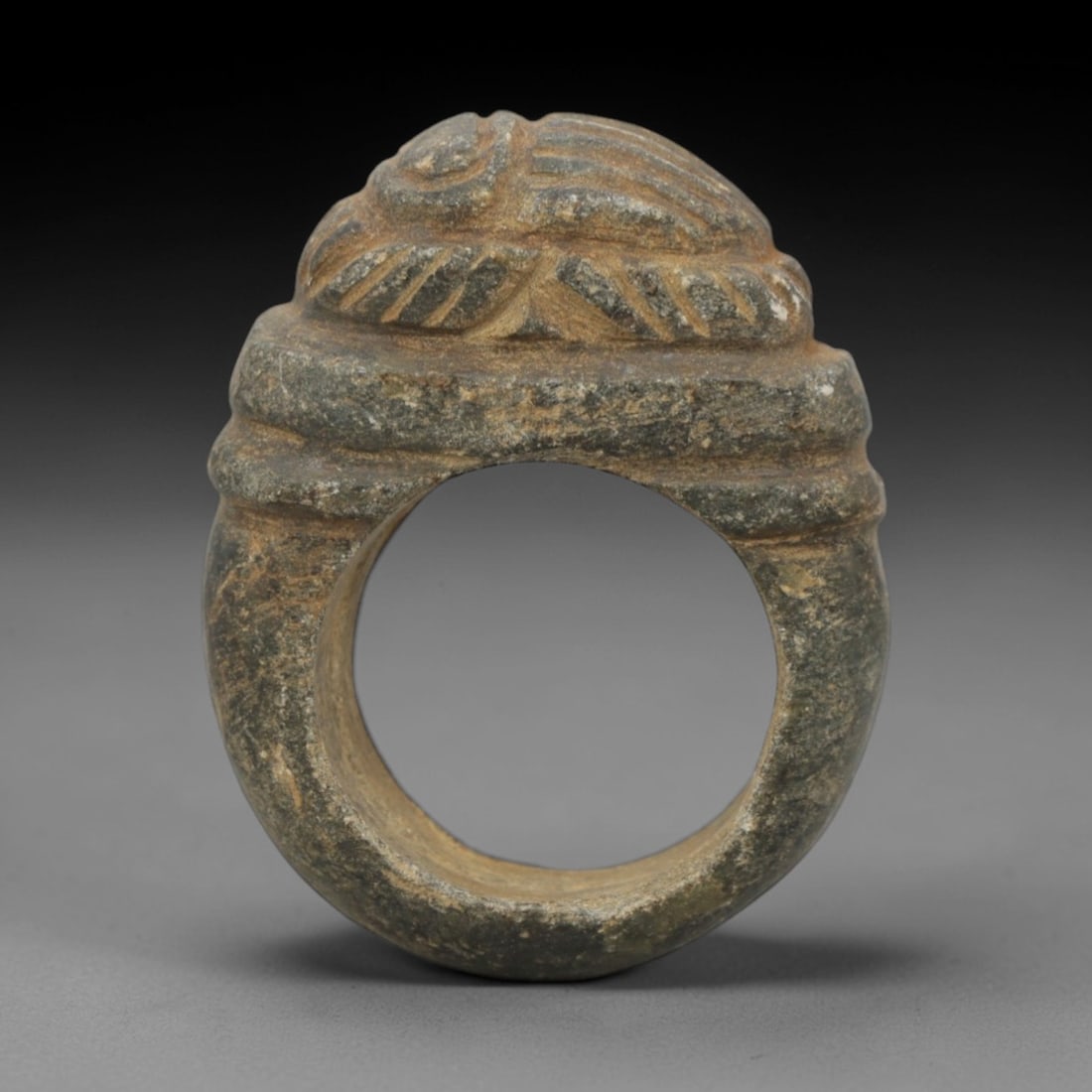 Ancient Steatite Scarab Ring - Achaemenid Signet Ring, 34ZQ: Carved from steatite, this ancient Achaemenid scarab ring features a stylized scarab motif with linear detailing, characteristic of Achaemenid glyptic art. The ring exhibits a smooth, aged patina cons