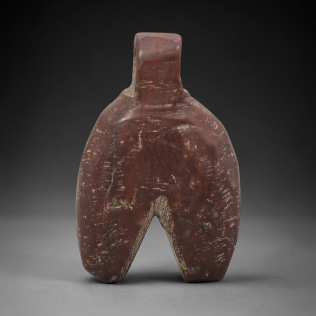 Ancient Near Eastern Stone Split Amulet - Carved Pendant Figure, 8ZV: This amulet is carved from a rich, reddish-brown stone with natural banding, likely siltstone or a similar sedimentary rock, with a distinct split lower form and rectangular suspension loop at the top