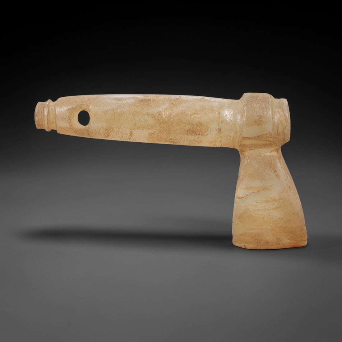 Ancient Chalcedony Axe Amulet - Near Eastern Protective Ritual Relic, 10AL: Crafted from translucent pale chalcedony, this T-shaped axe amulet mirrors the form of a functional ceremonial axe, with a long tapering handle terminating in a pierced hole for suspension, and a broa