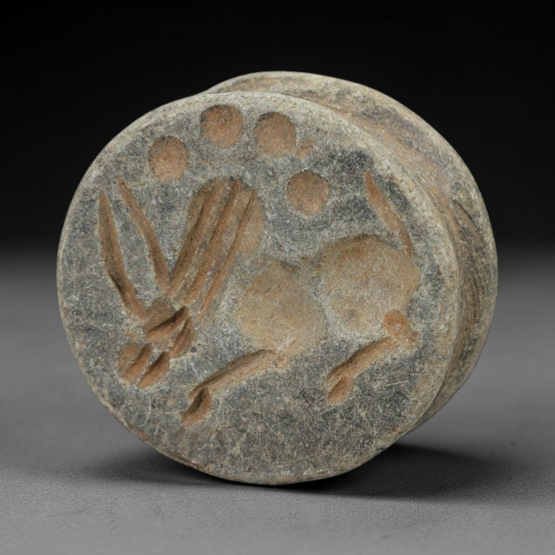 Ancient Stone Amulet - Near Eastern Stamp Seal Relic, 50AH: Carved from stone, this ancient Near Eastern double convex stamp seal amulet features a stylized animal motif typical of early glyptic art in the region. The piece exhibits precise linear detailing an