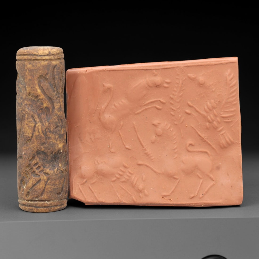 Ancient Steatite Cylinder Seal - Mesopotamian Animal & Avian Scene, 86ZR: Carved from dense steatite, this ancient Mesopotamian cylinder seal features a dynamic linear relief composition of equine, avian, and quadrupedal figures, executed in the characteristic glyptic style