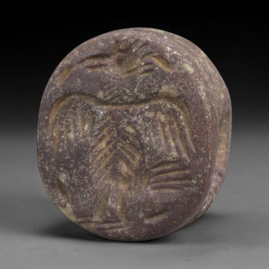 Ancient Steatite Stamp Seal - Sasanian Vulture, 46AK: Carved from steatite, this hemispherical Sasanian stamp seal features a central vulture motif with incised details defining its outstretched wings, head, and body, consistent with Sasanian glyptic art