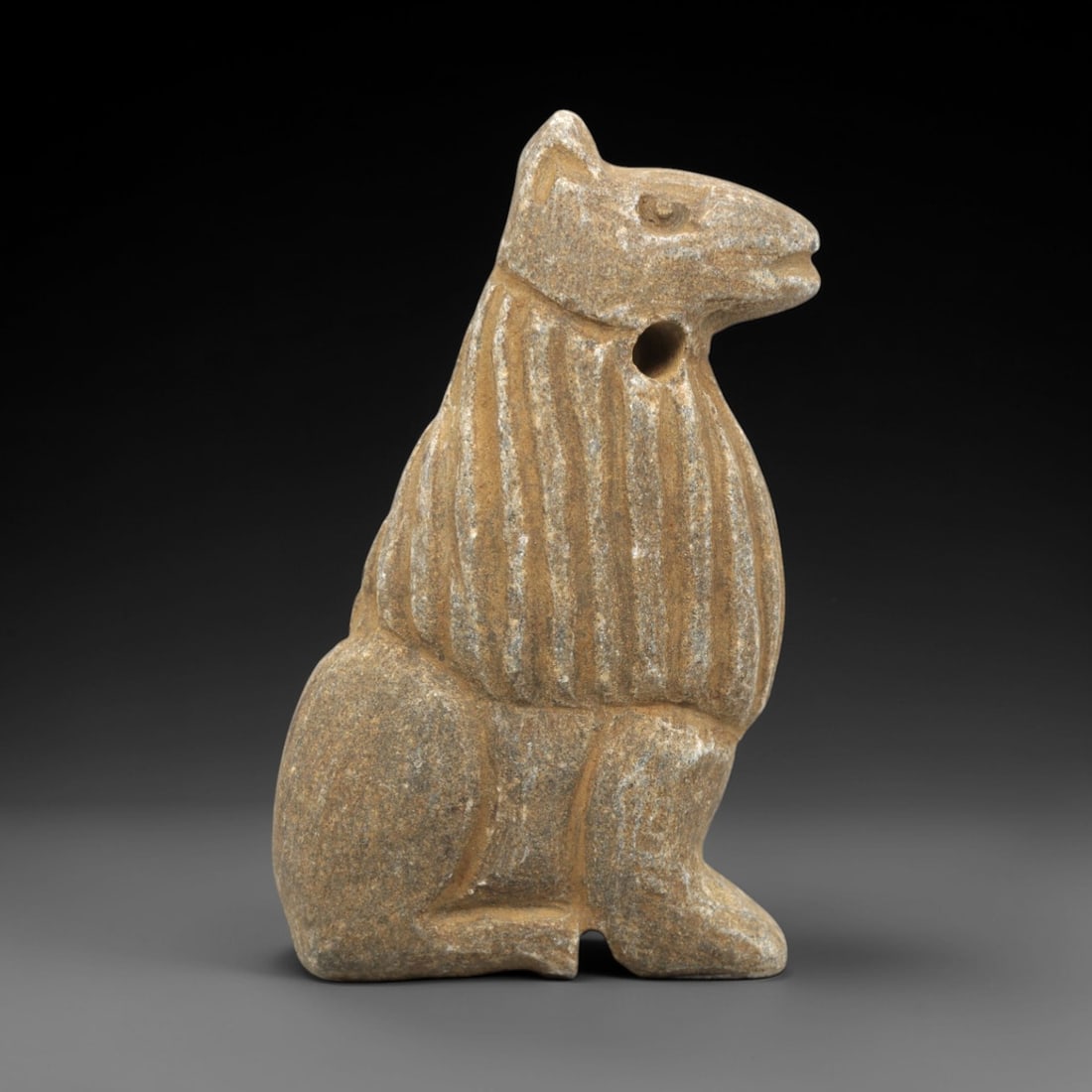 Ancient Near Eastern Stone Zoomorphic Amulet - Figurine, 39ZR: This artifact is a carved stone zoomorphic amulet, crafted from a granular, tan-brown stone with a textured, weathered surface and natural earthy patina. The piece takes the form of a seated, stylized