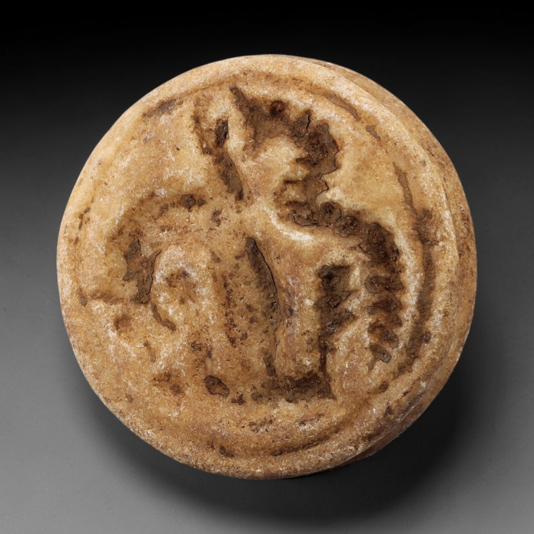 Ancient Steatite Stamp Seal - Vulture Motif, 91AG: Carved from steatite stone, this ancient stamp seal features a finely executed vulture motif in intaglio, characteristic of Near Eastern glyptic art. The carving displays precise detail in the bird's