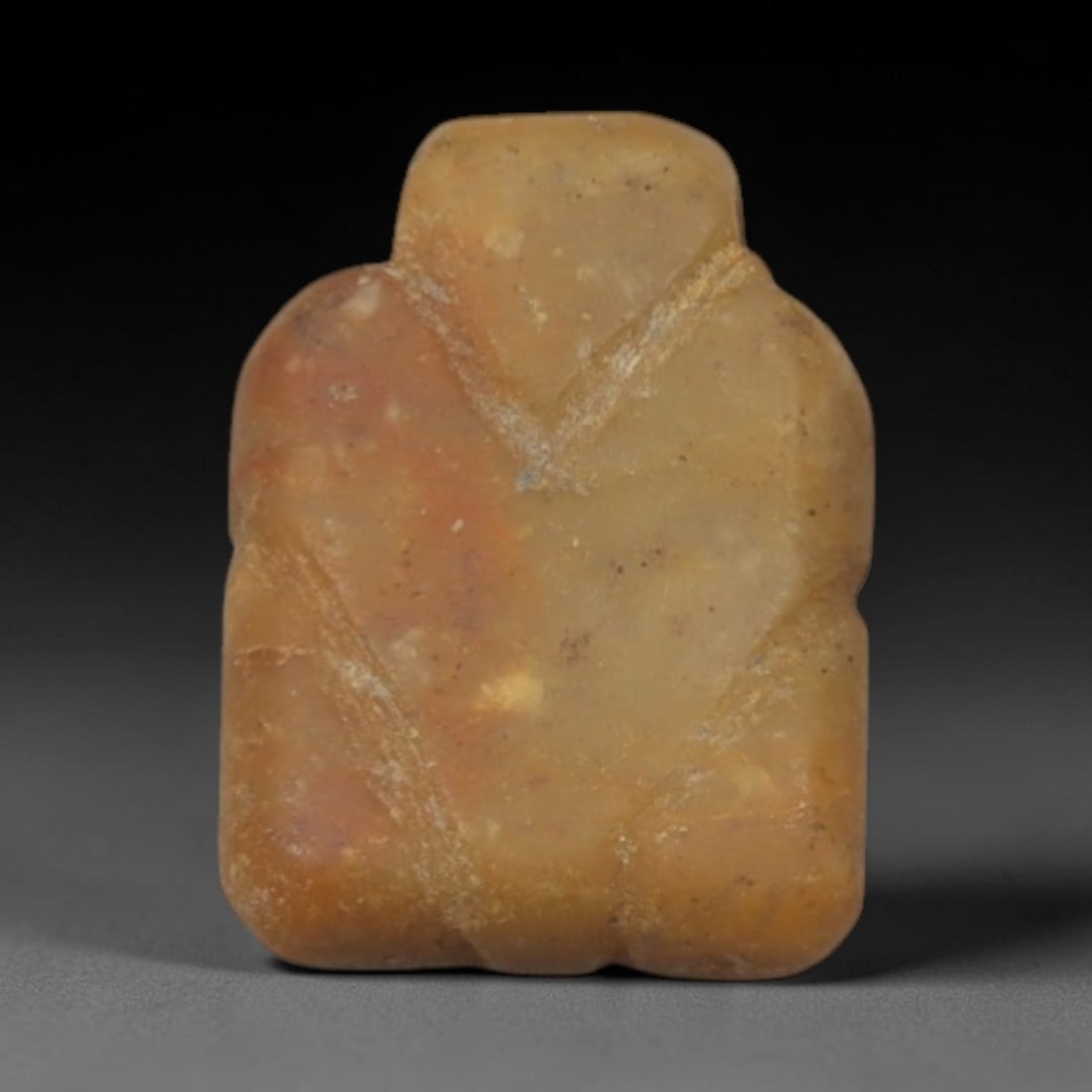 Ancient Yellow Stone Anthropomorphic Idol - Near Eastern Miniature Figurine, 65XP: Carved from a warm, pale yellow stone, this miniature anthropomorphic idol depicts a stylized humanoid figure, a classic motif in ancient Near Eastern portable ritual art. The form is compact and geom