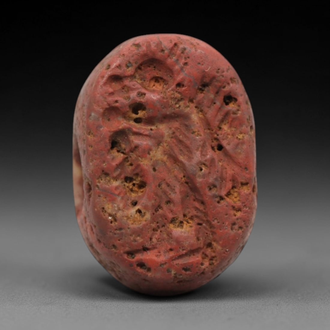Ancient Stone Hemispherical Stamp Seal - Near Eastern Avian Amulet, 27ZS: This ancient Near Eastern hemispherical stamp seal is carved from a porous, reddish stone, likely brecciated jasper or hematite, with a heavily weathered, earthy patina and natural surface pitting. Th