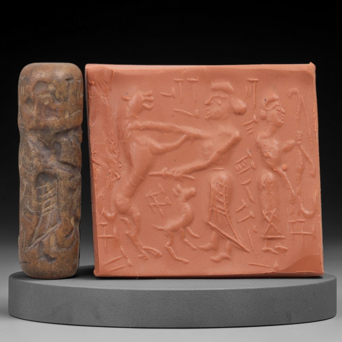 Ancient Steatite Cylinder Seal - Mesopotamian Narrative Combat Scene, 62AN: Carved from dense steatite, this ancient Mesopotamian cylinder seal features a dynamic linear relief composition of human figures interacting with animal figures in a narrative combat scene, intersper