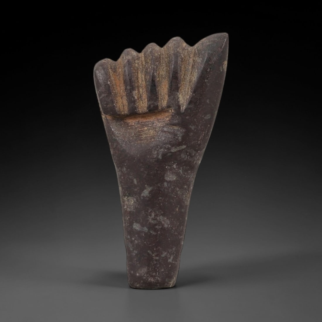 Ancient Egyptian Stone Amulet - Fist-Shaped Carving, 61AG: Carved from stone, this ancient Egyptian amulet takes the form of a fist, a motif associated with protection and strength in ancient Egyptian iconography. The stylized carving features a compact, roun