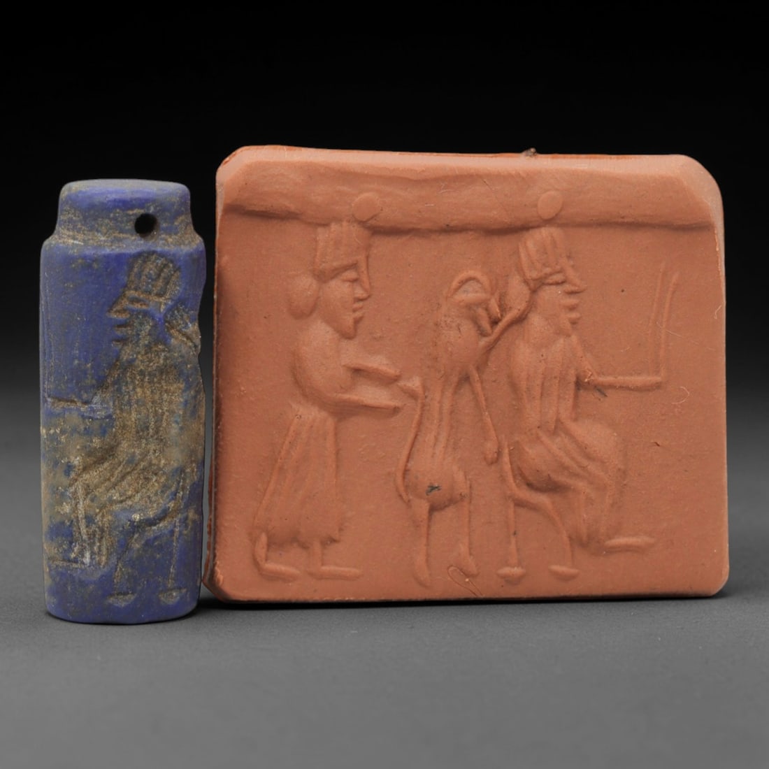 Ancient Lapis Lazuli Cylinder Seal - Near Eastern Glyptic Art, 46ZQ: Carved from lapis lazuli stone, this ancient Near Eastern cylinder seal features a cylindrical form with raised relief carvings depicting a stylized human figure with detailed linear patterns. The sea
