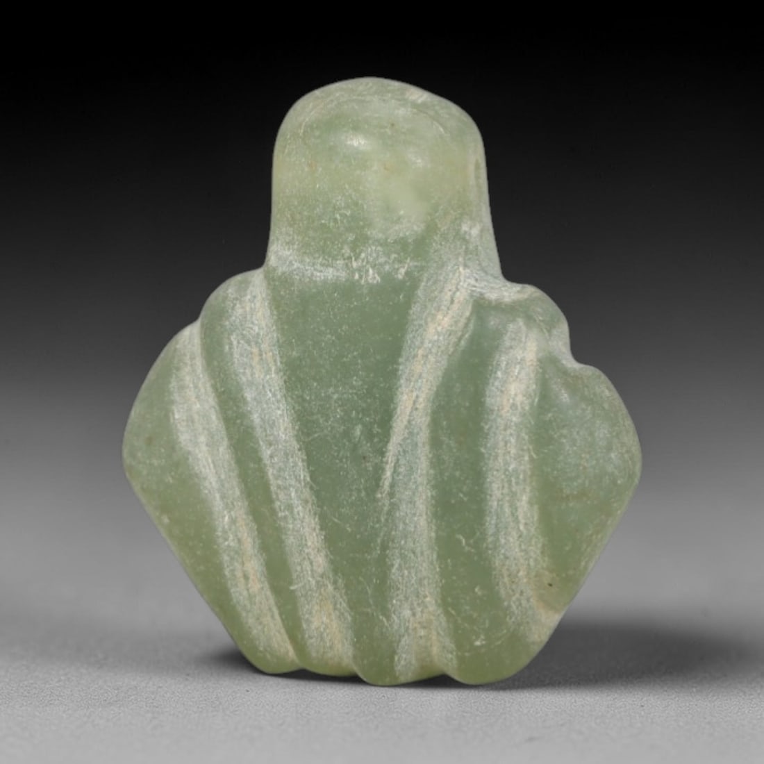 Ancient Serpentine Lotus Amulet - Egyptian Figurine, 29AR: This artifact is carved from pale, translucent green serpentine, exhibiting a smooth, matte finish with subtle natural inclusions and faint surface wear consistent with age. The form is a stylized lot