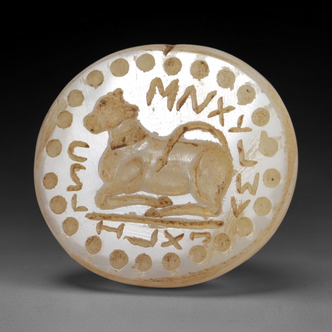 Ancient Chalcedony Stamp Seal - Near Eastern Bull Amulet, 30AR: Crafted from translucent chalcedony, this stamp seal exhibits precise intaglio carving characteristic of Near Eastern glyptic art. The obverse depicts a recumbent bull, a symbol of strength and divini