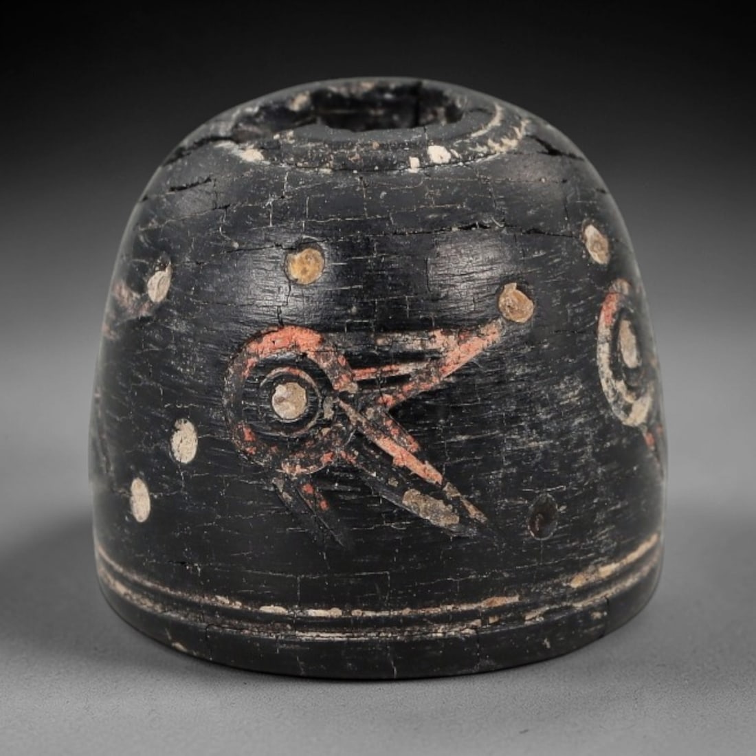 Ancient Jet Stone Spindle Whorl - Near Eastern Dot-in-Circle Motif, 82XR: This ancient Near Eastern spindle whorl is crafted from jet stone, featuring incised dot-in-circle motifs encircling the central perforation. The compact, rounded form is a traditional textile tool us