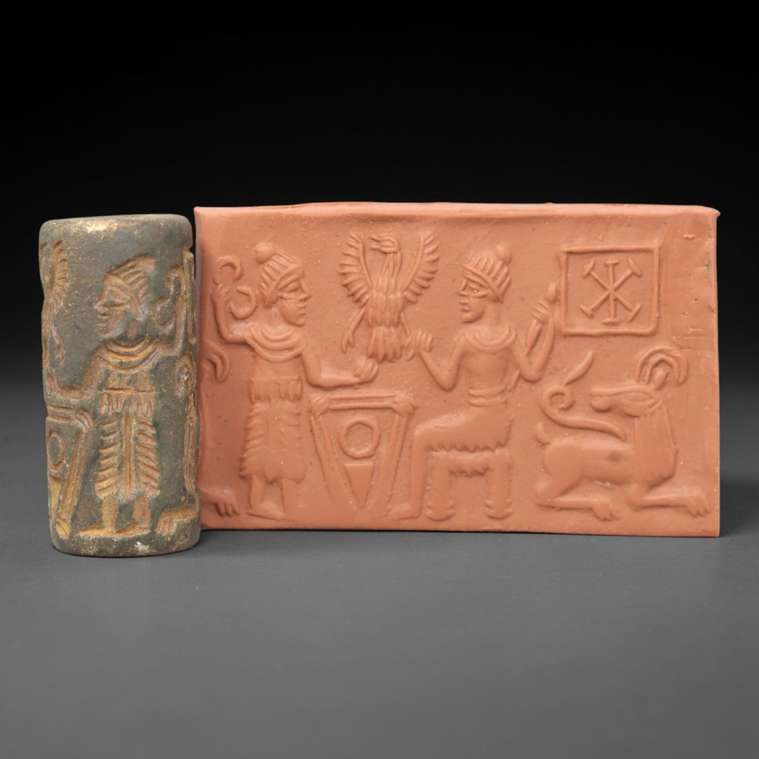 Ancient Steatite Cylinder Seal - Mesopotamian Royal Ritual & Eagle Symbol Scene, 19ZP: Carved from dark, weathered steatite, this ancient Mesopotamian cylinder seal depicts a formal royal ritual scene, executed with precise glyptic craftsmanship characteristic of the Neo-Assyrian period
