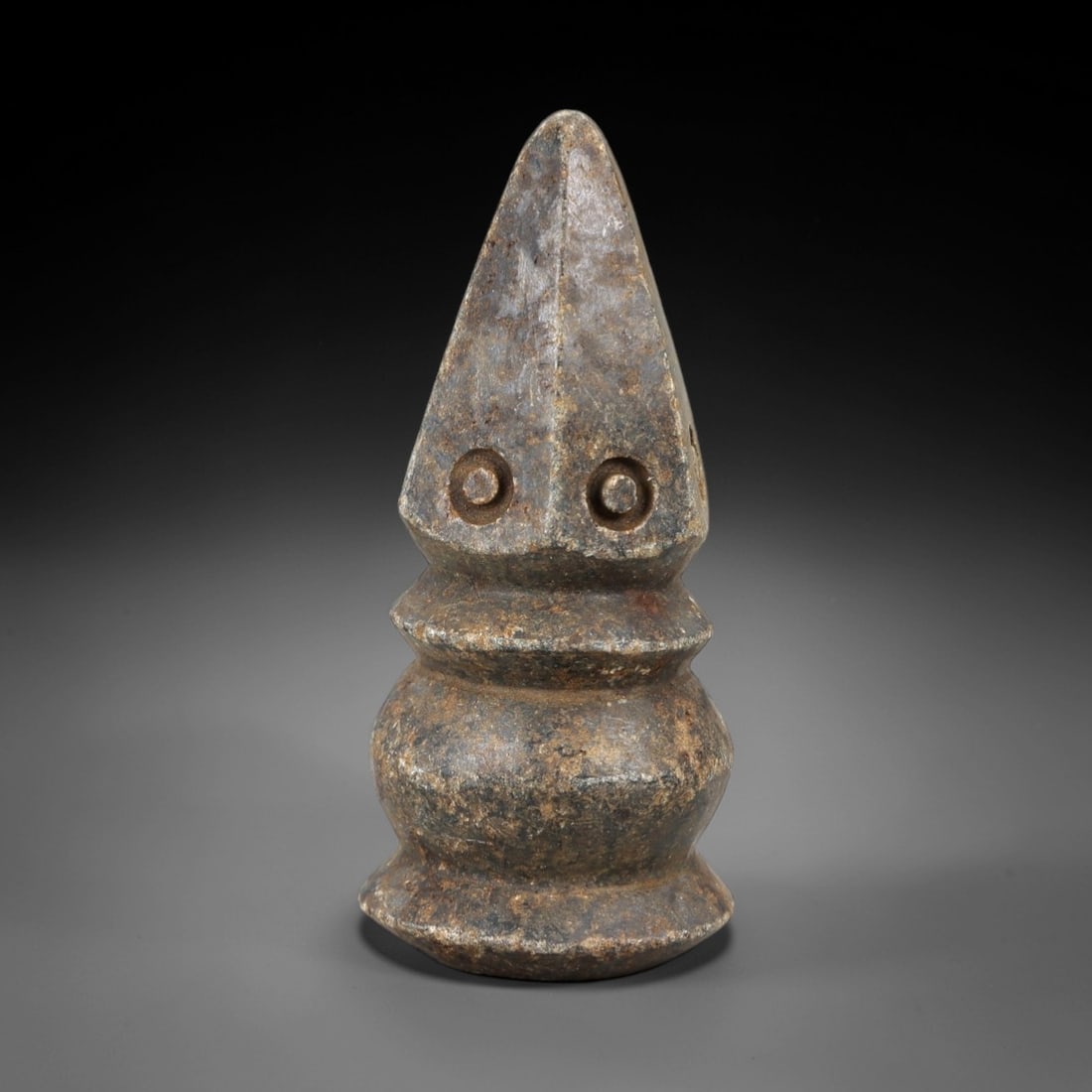 Ancient Stone Eye Idol - Near Eastern Amulet Figurine, 17AM: This artifact is carved from a dense, weathered stone with a mottled, earthy patina indicative of long-term burial exposure. The form consists of a tapering, pyramidal upper section with two deeply in