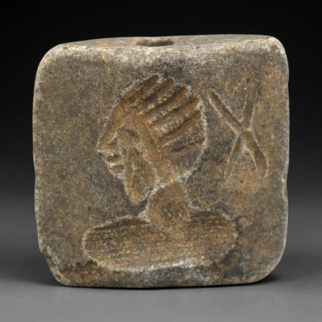 Ancient Schist Double Convex Intaglio Bead Amulet - Near Eastern Dual Deity, 33ZS: This ancient Near Eastern double convex intaglio bead amulet is carved from dense, weathered schist, with a muted, earthy patina indicative of long-term burial. The bead features two distinct intaglio