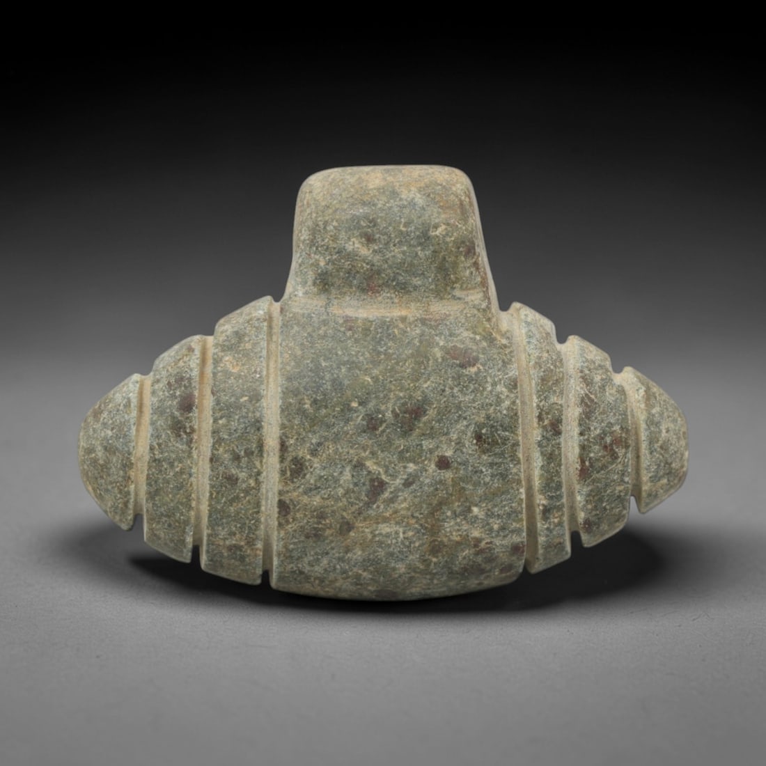 Ancient Stone Abstract Amulet - Near Eastern Pendant, 46XQ: Carved from a mottled greenish-grey stone with natural patination, this amulet features a symmetrical, abstract form with a raised central terminal and segmented, bulbous lateral extensions. Incised h