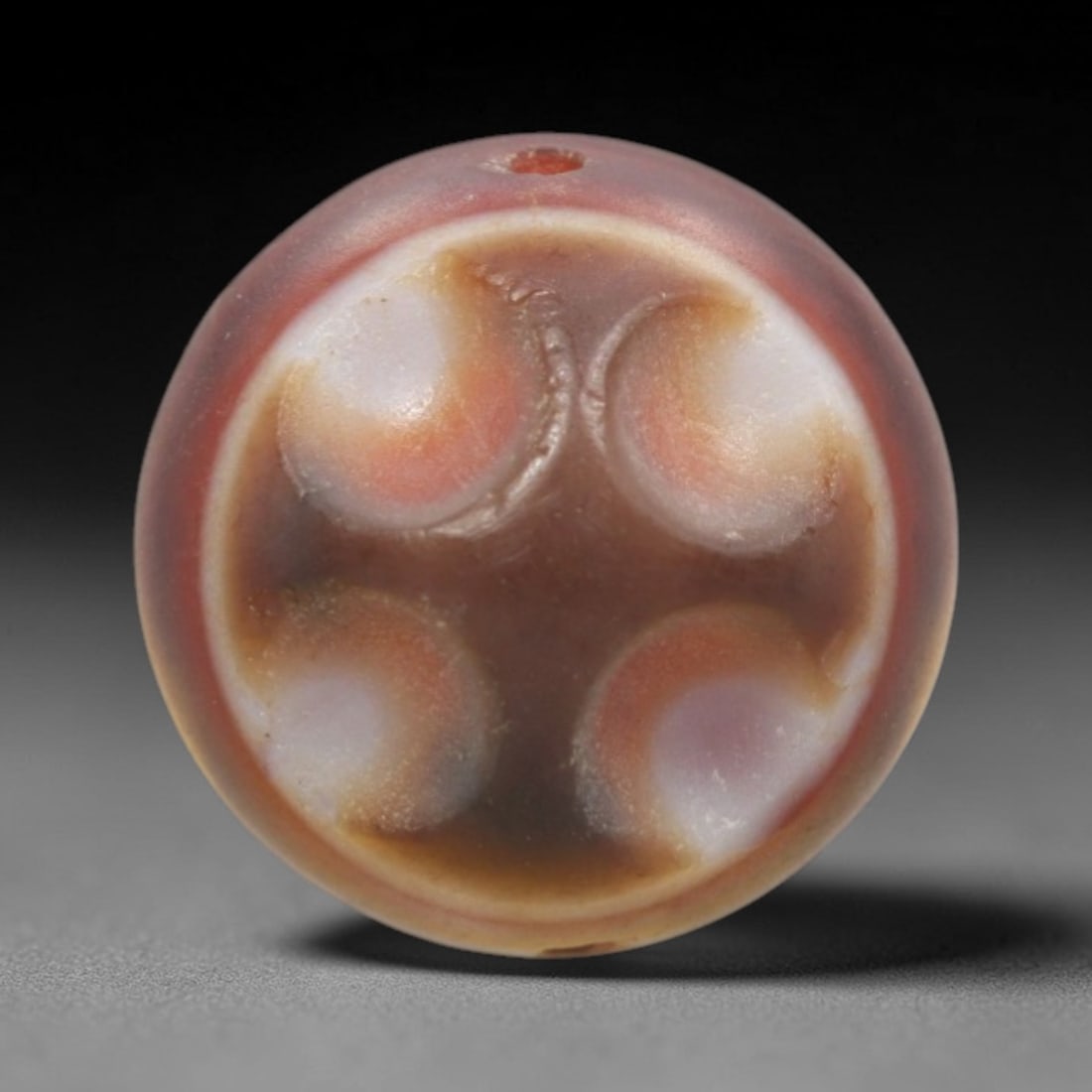 Antique Agate Four-Eye Bead - Central Asian Protective Amulet Pendant, 7ZW: Carved from banded agate with a warm reddish-brown base and creamy white-orange inclusions, this bead features a symmetrical four-eye motif with raised, crescent-shaped segments arranged in a cross pa