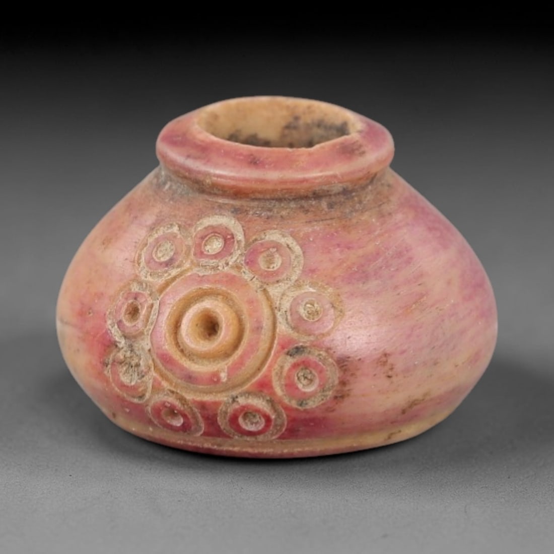 Ancient Near Eastern Bone Spindle Whorl - Dot-in-Circle Motif, 98AH: Carved from ancient bone, this Near Eastern spindle whorl features a continuous dot-in-circle motif encircling its central perforation, a design with apotropaic significance in ancient Near Eastern cu