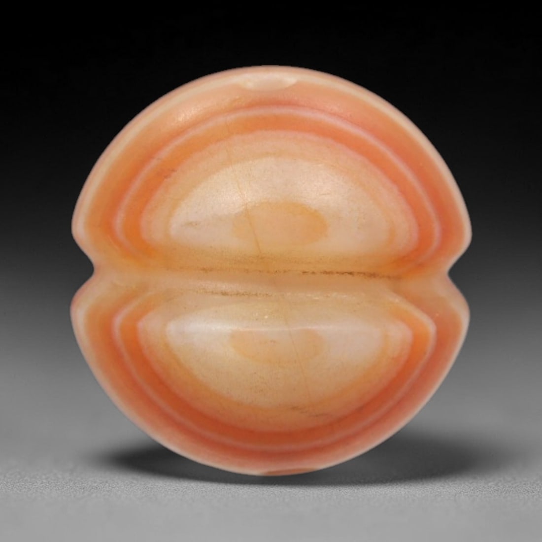 Antique Agate Double Eye Bead - Central Asian Gemstone Pendant, 9ZW: Carved from banded agate with soft peach and creamy white concentric banding, this bead features a symmetrical double-eye motif with a subtle central indentation, creating a mirrored, organic form. A