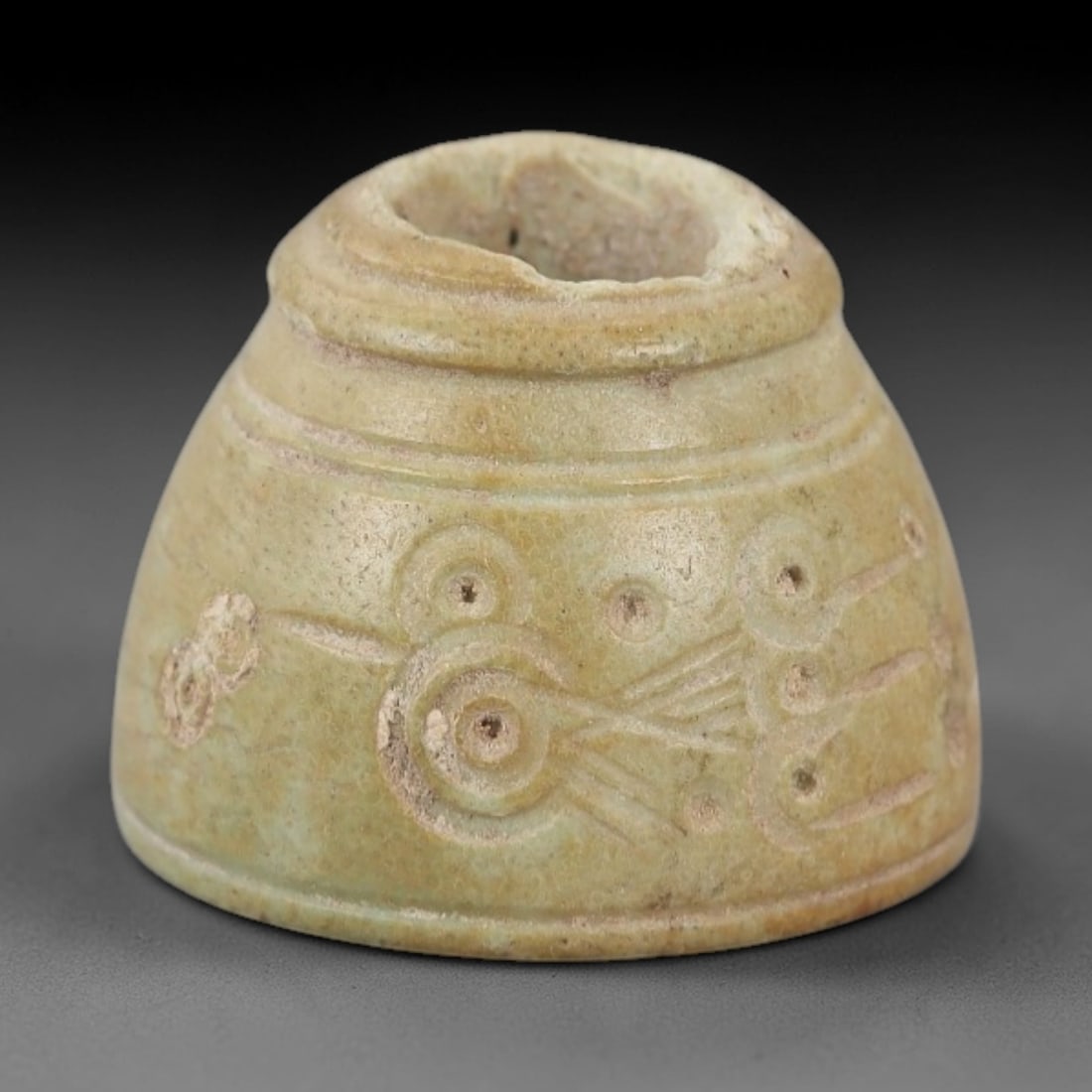 Ancient Near Eastern Bone Spindle Whorl - Dot-in-Circle Motif, 96AH: Carved from ancient bone, this Near Eastern spindle whorl features a continuous dot-in-circle motif encircling its central perforation, a design with apotropaic significance in ancient Near Eastern cu