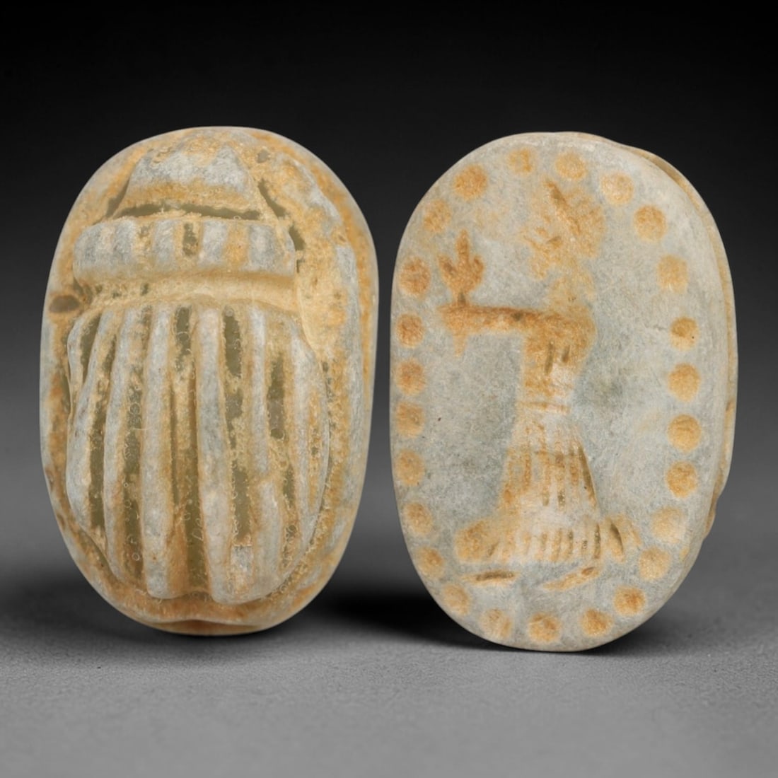 An Ancient Near Eastern Stone Scarab Stamp Seal, 1st Millennium BCE, 93AC: Carved from pale, weathered stone with natural surface encrustation and subtle tonal variation, the object is formed as an oval scarab seal. The dorsal side is modeled in low relief with a segmented c