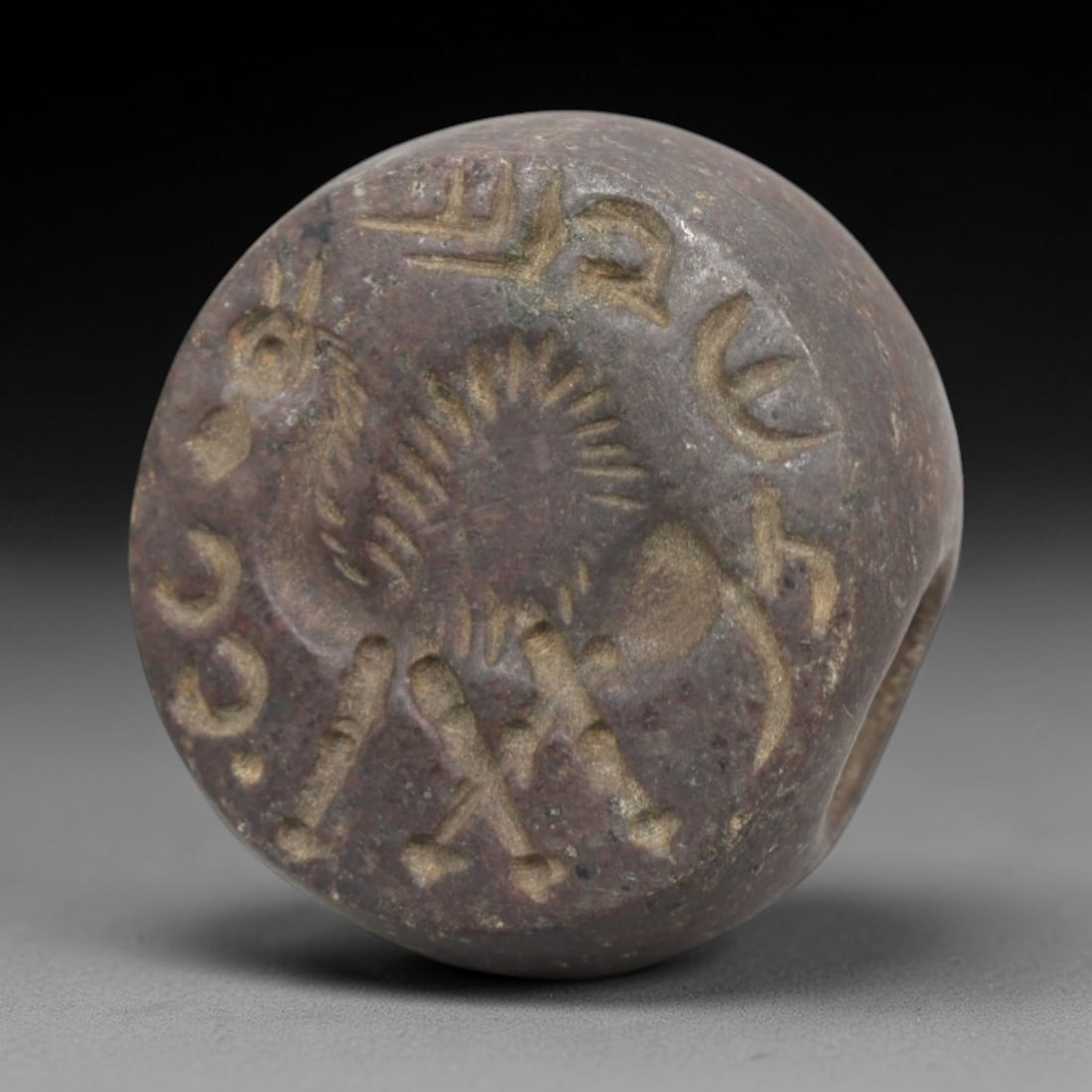 Ancient Stone Hemispherical Stamp Seal - Near Eastern Animal & Script, 41ZP: Crafted from a dense, reddish-brown stone, this hemispherical stamp seal bears a deeply incised composition featuring a stylized quadrupedal animal with a spiked mane, rendered in linear relief with d