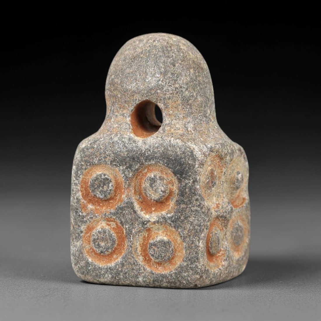Ancient Schist Dice Amulet - Near Eastern Gaming Pendant, 66AK: Carved from gray schist, this compact amulet takes the form of a miniature gaming die, with square faces incised with circular dot motifs (resembling die pips) and a central perforation at the top for