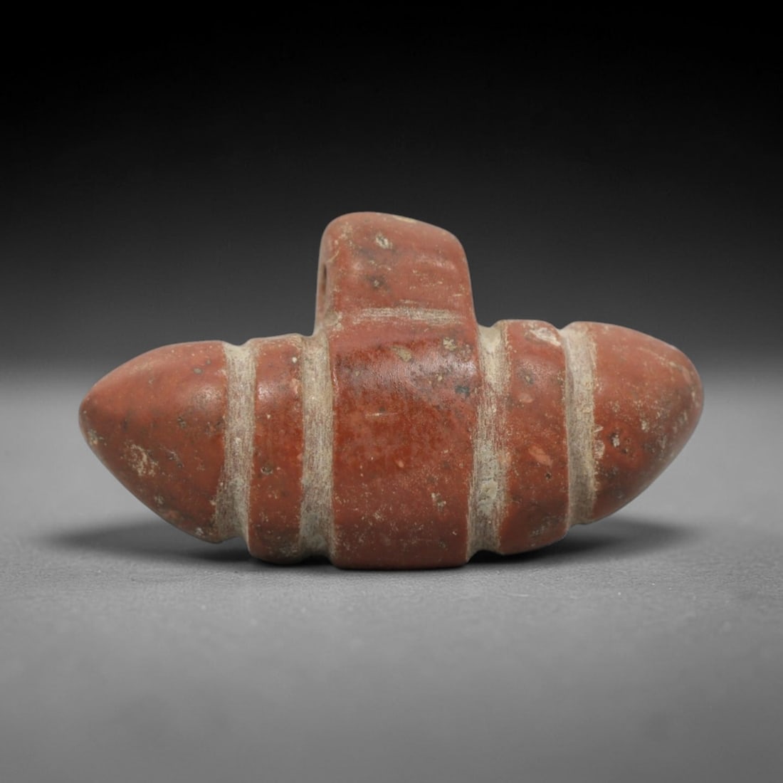 Ancient Near Eastern Red Stone Double-Bulb Amulet - Carved Pendant Figure, 67ZT: This amulet is carved from a rich, deep red stone with natural mineral speckling and patination, likely brecciated jasper or red steatite, featuring a distinctive double-bulb (or double-pointed) form.