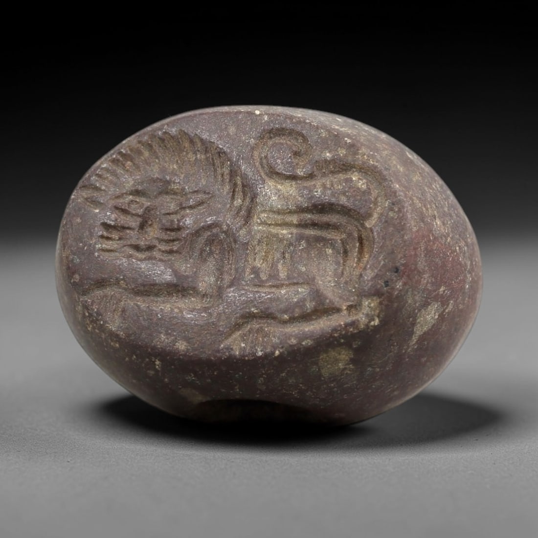 Ancient Stone Hemispherical Stamp Seal - Near Eastern Lion Amulet, 13AN: This ancient Near Eastern hemispherical stamp seal is carved from a dense, reddish-brown stone, likely steatite or chlorite, with a weathered, earthy patina consistent with ancient burial contexts. Th