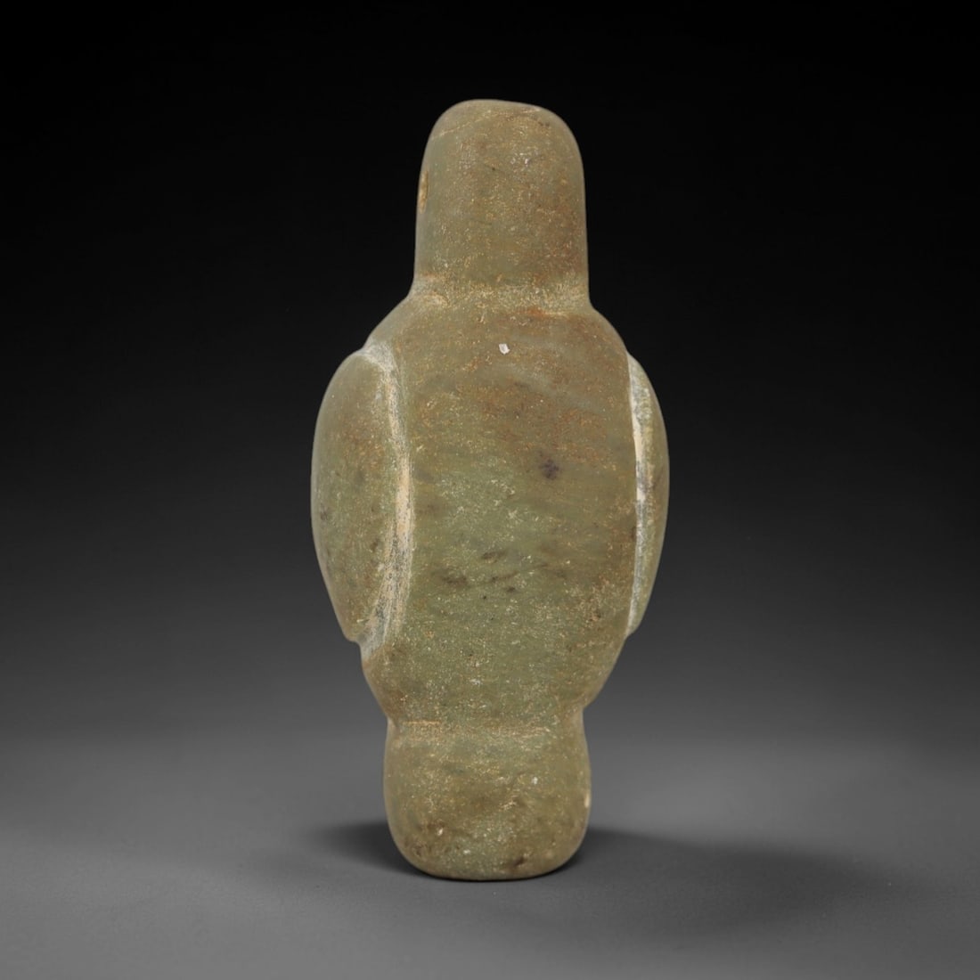 Ancient Stone Bird Amulet - Egyptian Style Figurine, 100AE: Carved from grey stone, this ancient Egyptian-style bird amulet features a stylized avian form with defined head, body, and wing details, and a suspension hole at the top for wear. The carving exhibit