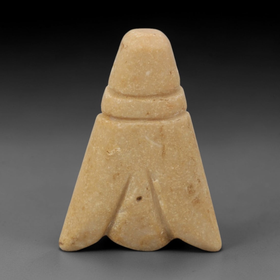 Ancient Stone Fly - Egyptian Amulet Pendant, 35XR: Carved from pale beige stone, this amulet depicts a stylized fly with a domed head, narrow neck, and broad, wing-like lower body terminating in a split tail. The form and iconography are characteristi