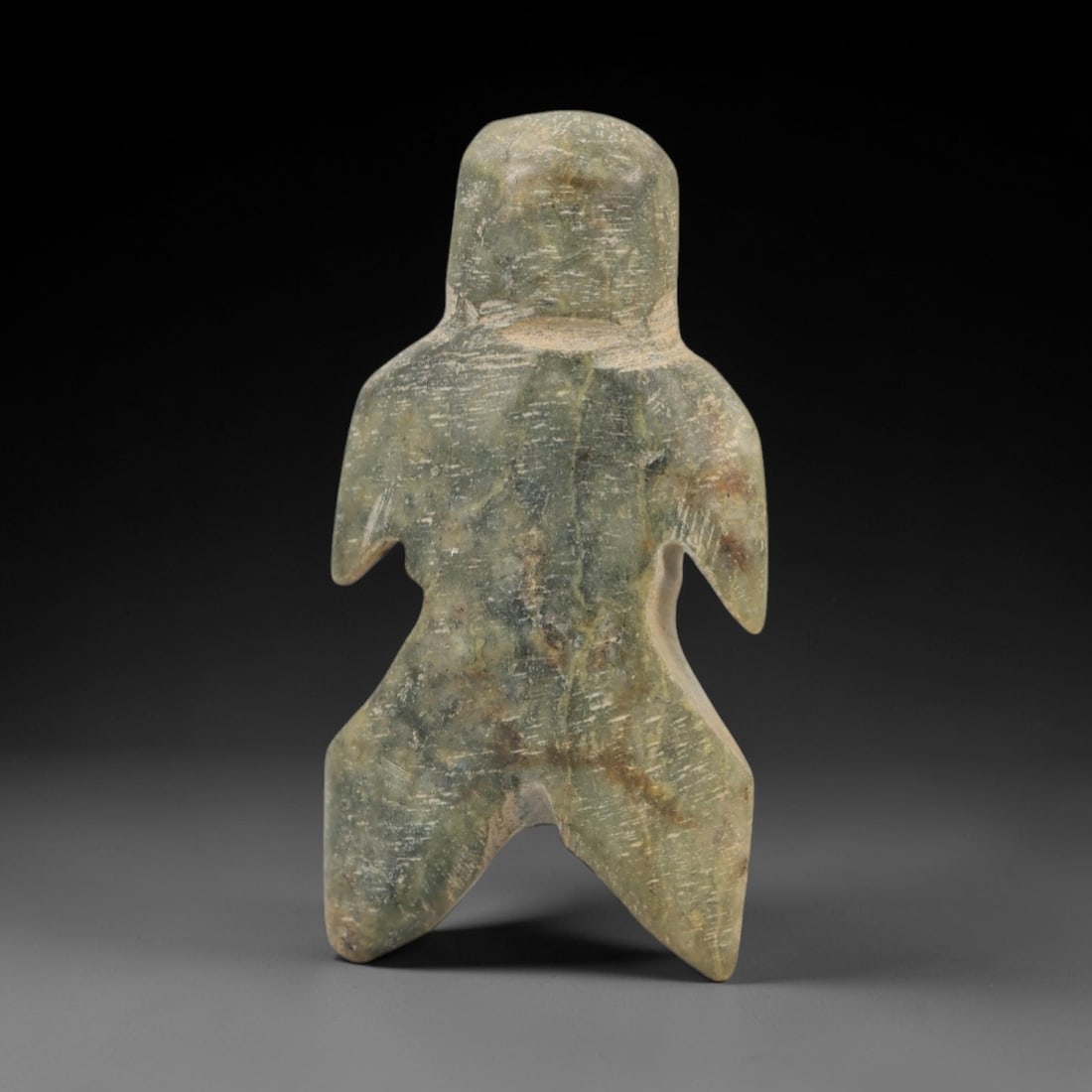 Ancient Egyptian Stone Figurine - Anthropomorphic Carved Amulet, 64AE: Carved from stone, this ancient Egyptian anthropomorphic figurine features linear decorative patterns on its body, a style typical of protective amulets from the Late Period. The compact form has a su