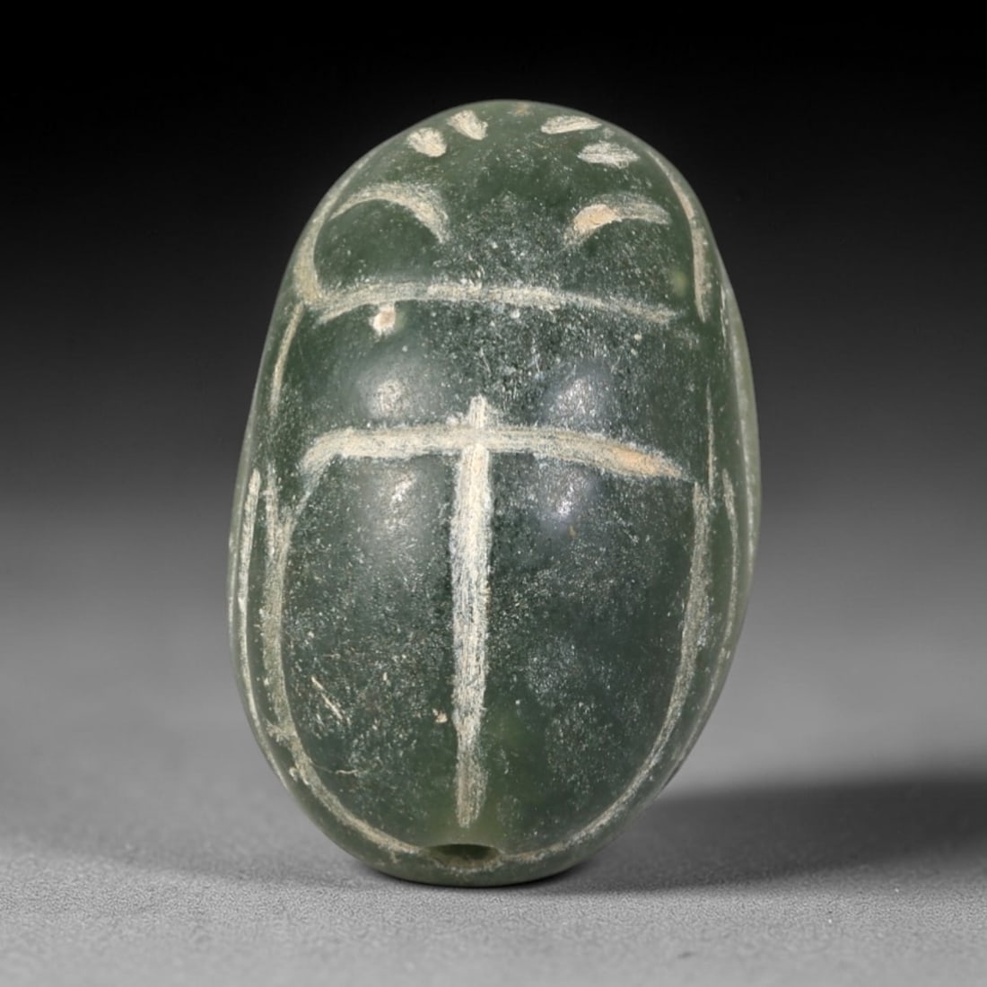 Ancient Serpentine Scarab Amulet - Egyptian Figurine, 57AR: This artifact is carved from deep green serpentine, exhibiting a smooth, polished surface with natural mineral inclusions and faint surface wear consistent with age. The form is a classic scarab amule