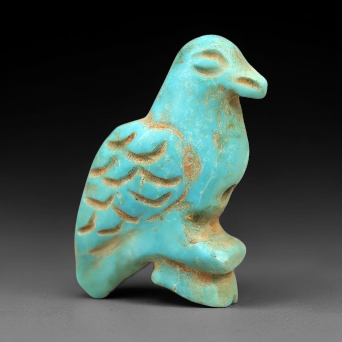 Ancient Turquoise Bird Amulet - Egyptian/Near Eastern Ritual Pendant, 46AN: Carved from turquoise, this amulet depicts a stylized perched bird with incised feather details, a defined beak, and a compact, balanced posture. The vibrant turquoise stone exhibits characteristic ve