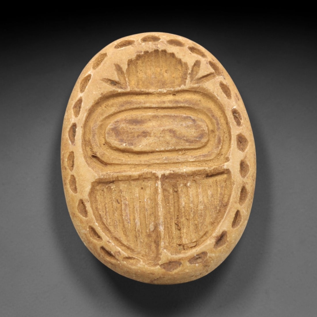 Ancient Steatite Scarab Stamp Seal - Egyptian Amulet, 97ZP: Carved from light tan steatite, this oval scarab stamp seal features incised dorsal detailing defining the beetle's elytra, head, and serrated border, characteristic of Egyptian craftsmanship. The rev