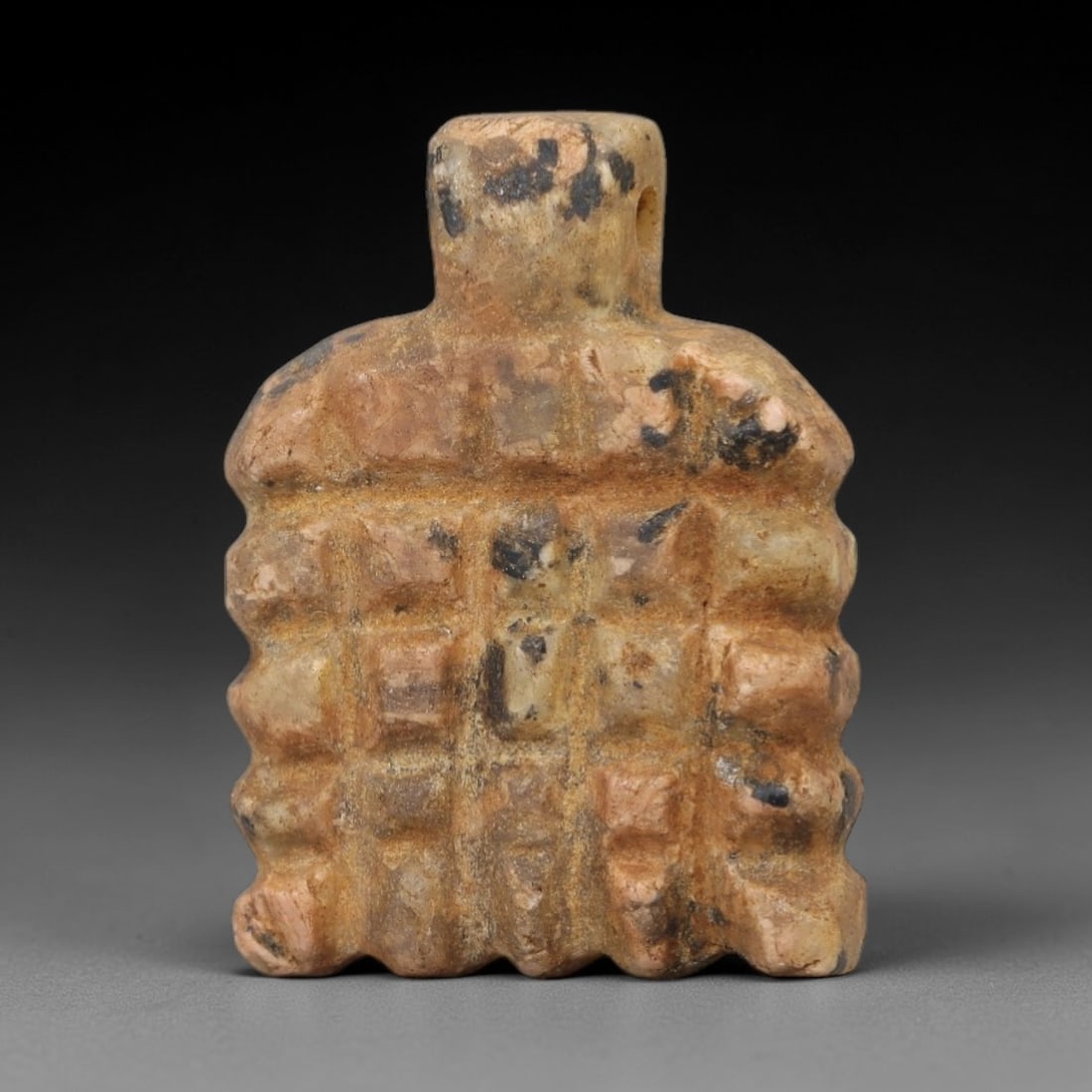 Ancient Egyptian Stone Amulet - Geometric Carved Pendant, 21AE: Carved from light-toned stone, this ancient Egyptian amulet features an elongated, tapering form with incised geometric detailing, a motif typical of Egyptian protective amulets. Craftsmanship is simp