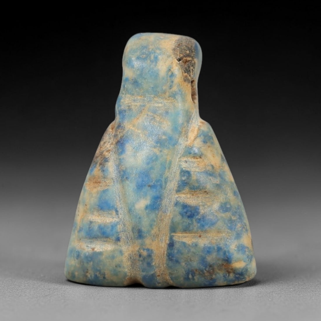 Ancient Lapis Lazuli Fly Amulet - Egyptian Ritual Pendant, 20AP: Carved from lapis lazuli, this amulet is formed in the shape of a fly, with a broad, trapezoidal body and a raised upper lug pierced for suspension, its surface incised with linear details defining th