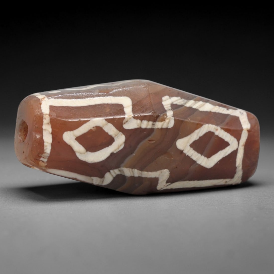 Ancient Agate Etched Dzi Bead - Himalayan Amulet, 73XV: Crafted from banded agate, this faceted bead features etched geometric motifs including diamond shapes and linear borders, executed in traditional Himalayan Dzi bead techniques. The form is a compact,