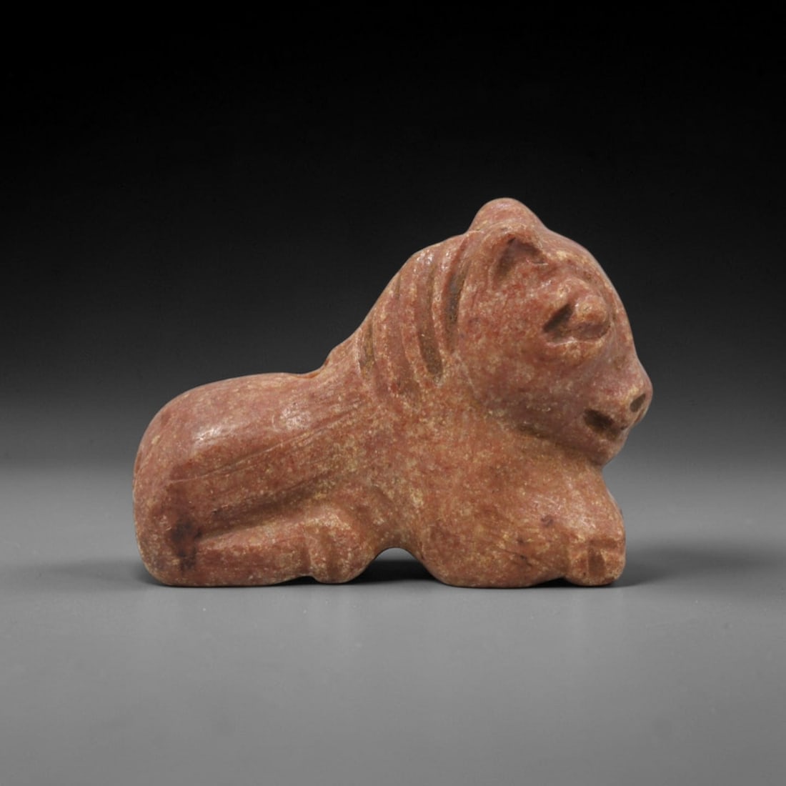 Ancient Stone Feline Amulet - Near Eastern Figurine, 3XT: This amulet is carved from a warm reddish stone with subtle earthy tonal variations and a natural matte patina across its surface, crafted using a simplified yet expressive carving technique that capt