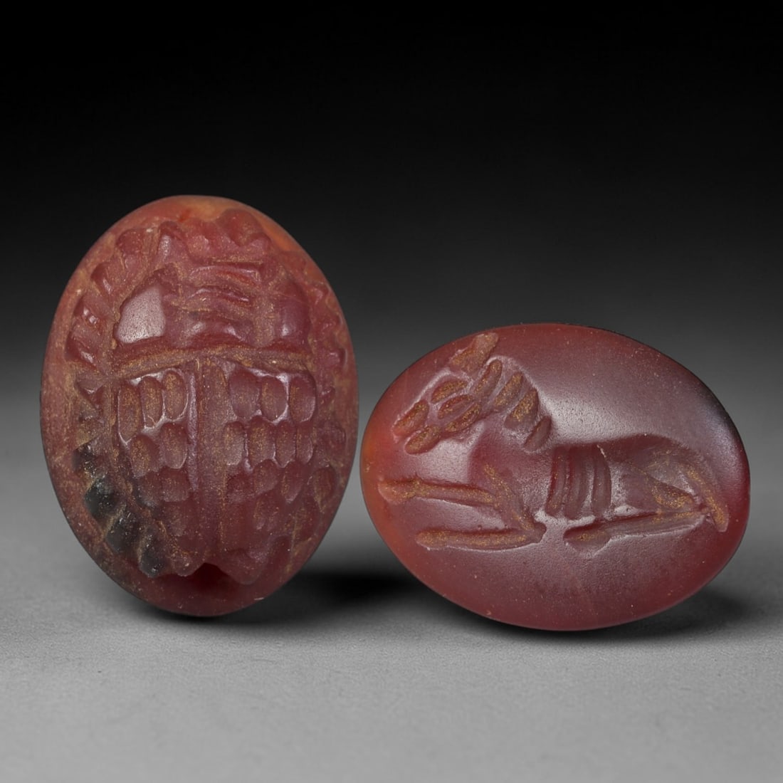 Ancient Carnelian Scarab Seal - Near Eastern Amulet, 46AS: Carved from carnelian, this double-sided amulet serves as both a scarab and a stamp seal, characteristic of Near Eastern artistic traditions. The obverse features a detailed scarab beetle with segment