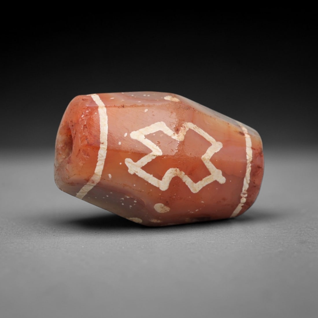 Ancient Carnelian Star Motif Dzi Bead - Himalayan Amulet, 74XV: Crafted from warm translucent carnelian, this faceted bead features a prominent etched white star-like motif, flanked by vertical linear bands and small dot accents, executed in traditional Himalayan