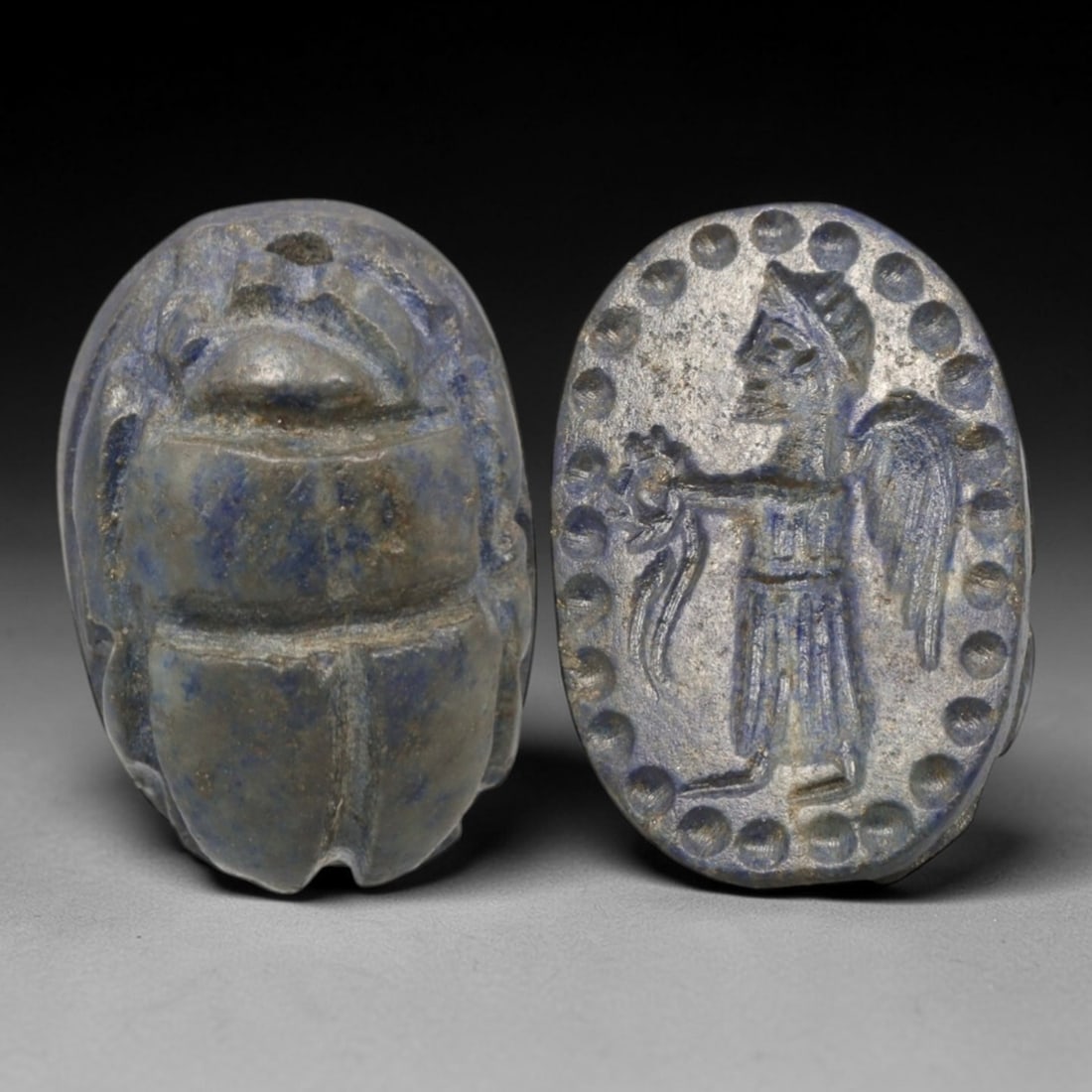 Ancient Lapis Lazuli Scarab - Near Eastern Winged Figural Seal, 34XT: This artifact is hand-carved from lapis lazuli, utilizing traditional ancient lapidary techniques consistent with Near Eastern Bronze Age seal craftsmanship. The object takes the form of a scarab beet