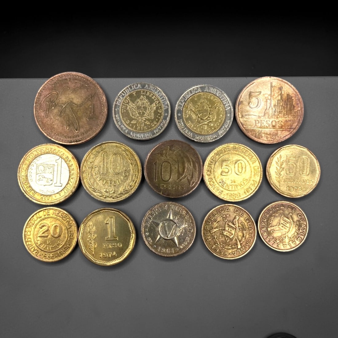 LATIN AMERICA: Sovereignty & Economic Evolution - 14-Piece Coins Set, 1960-2009, 19-29mm, 13ZJ: This curated 14-Piece Coins Set spans nearly half a century of Latin American numismatic history, featuring coins from Argentina, Venezuela, Guatemala, Panama, and other nations, ranging from 19 to 29